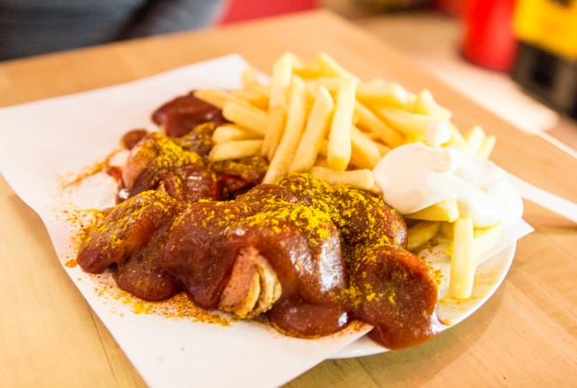 plate with food on a white napkin and wooden table