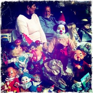 clown dolls in a market with a women and man in the background