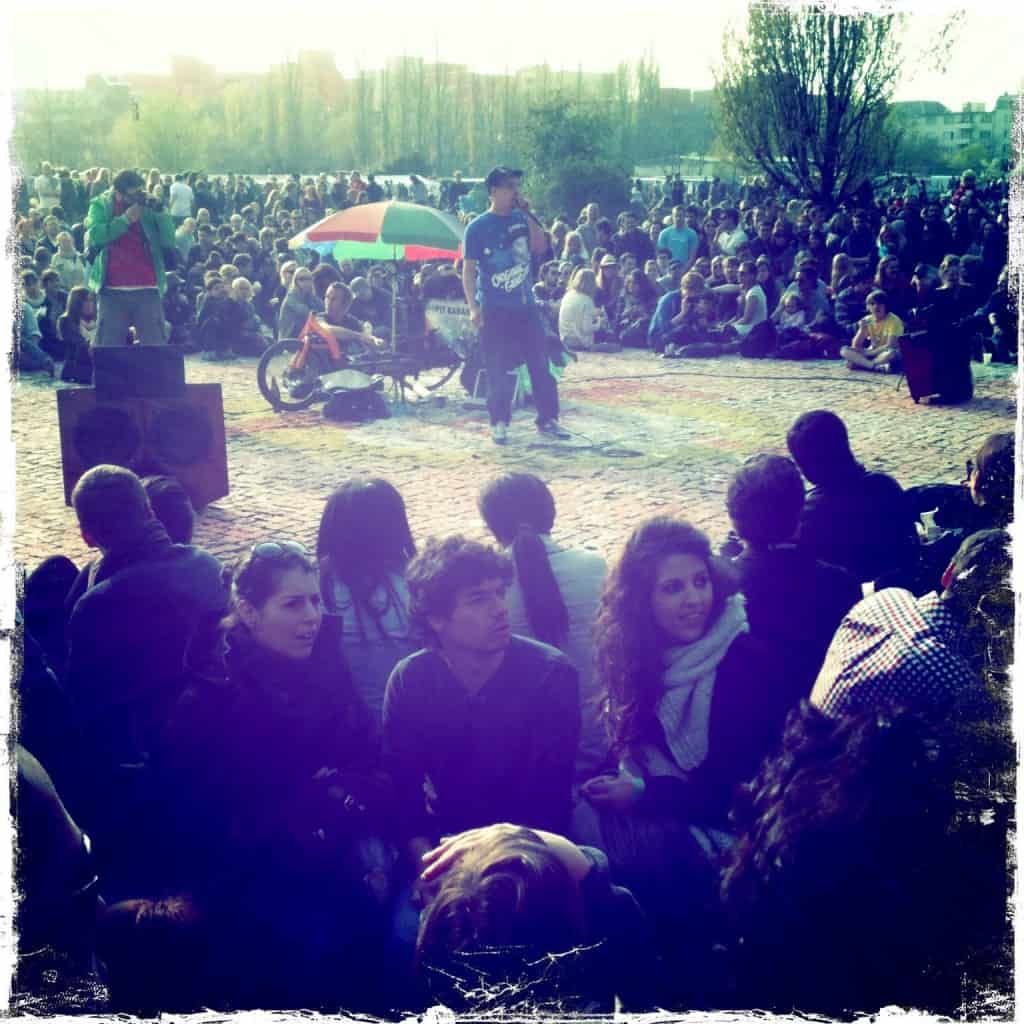 a very crowded park with a man in the center with a microphone