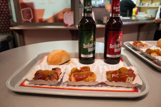 3 different types of Currywurst with two beers on a tray at the Currywurst Museum