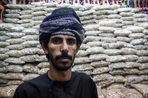 Incense seller in Muscat. Man with traditional headdress staring into camera