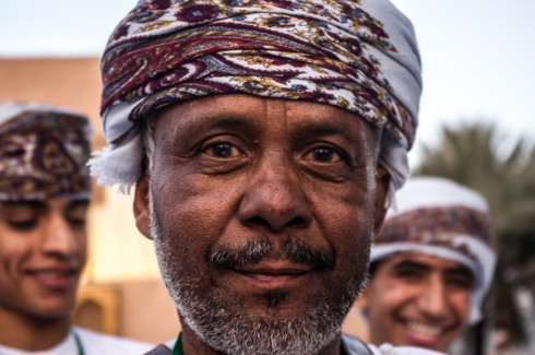 Omani Man in traditional head dress staring into the camera