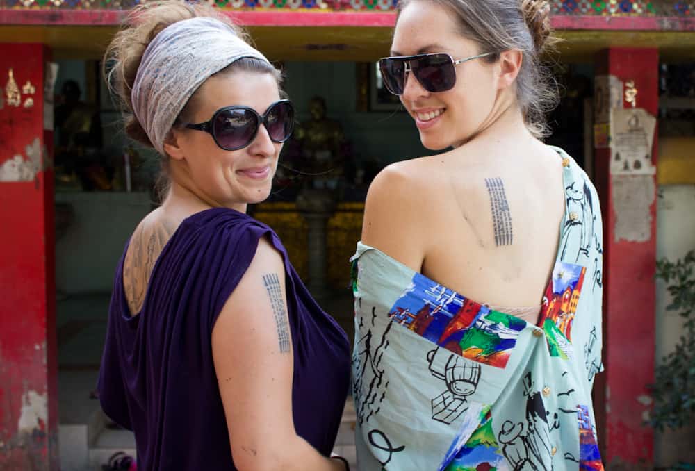 Two women with sunglasses looking backwards 