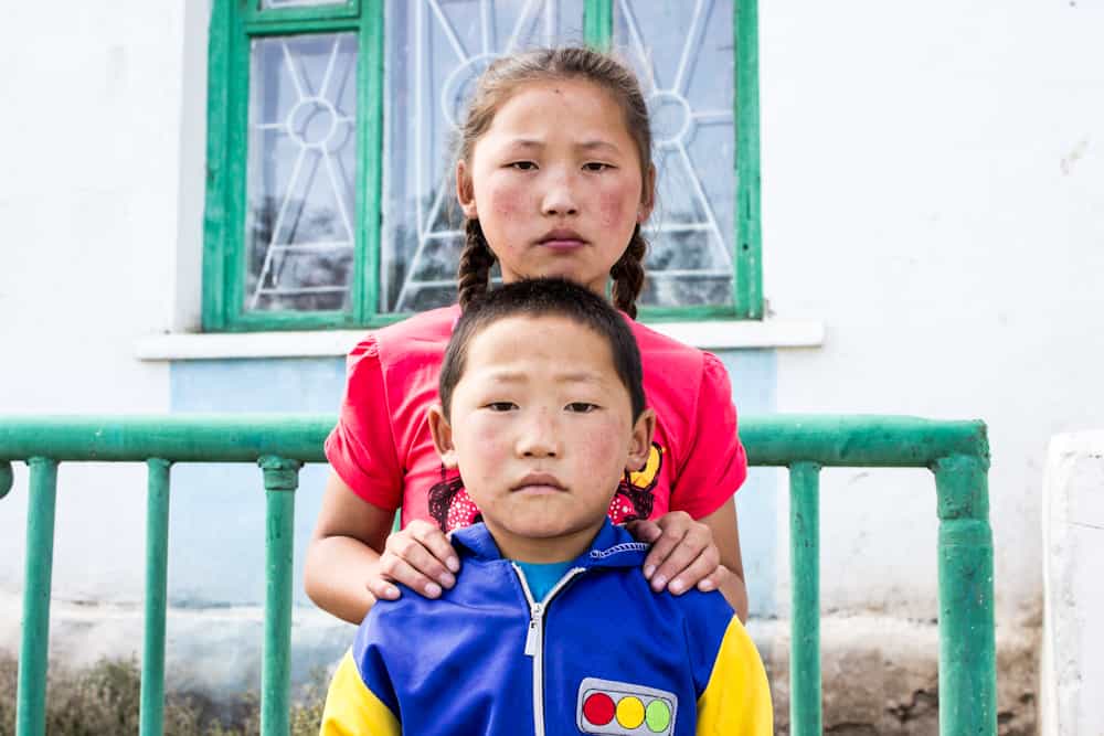 FACES OF MONGOLIA-9 small girl and boy looking straight at the camera without smiling