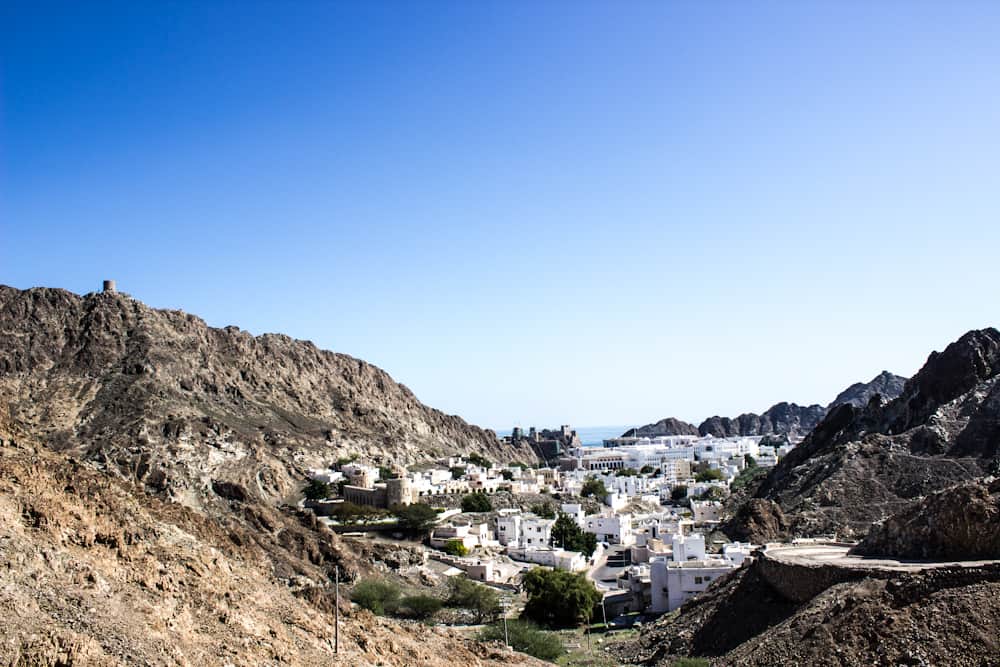 ocean town of white building among the mountains