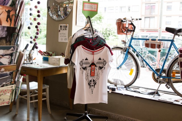 clothes rack with t-shirts and a bike