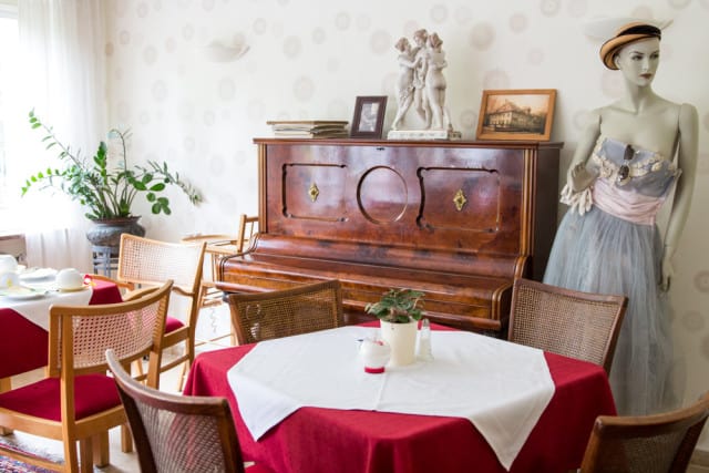 red and white table with wooden chairs and piano