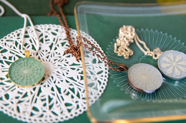 three necklaces on a green table
