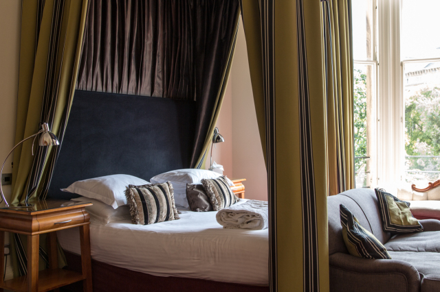 Luxury bed with gold curtains at the Bonham hotel in Edinburgh