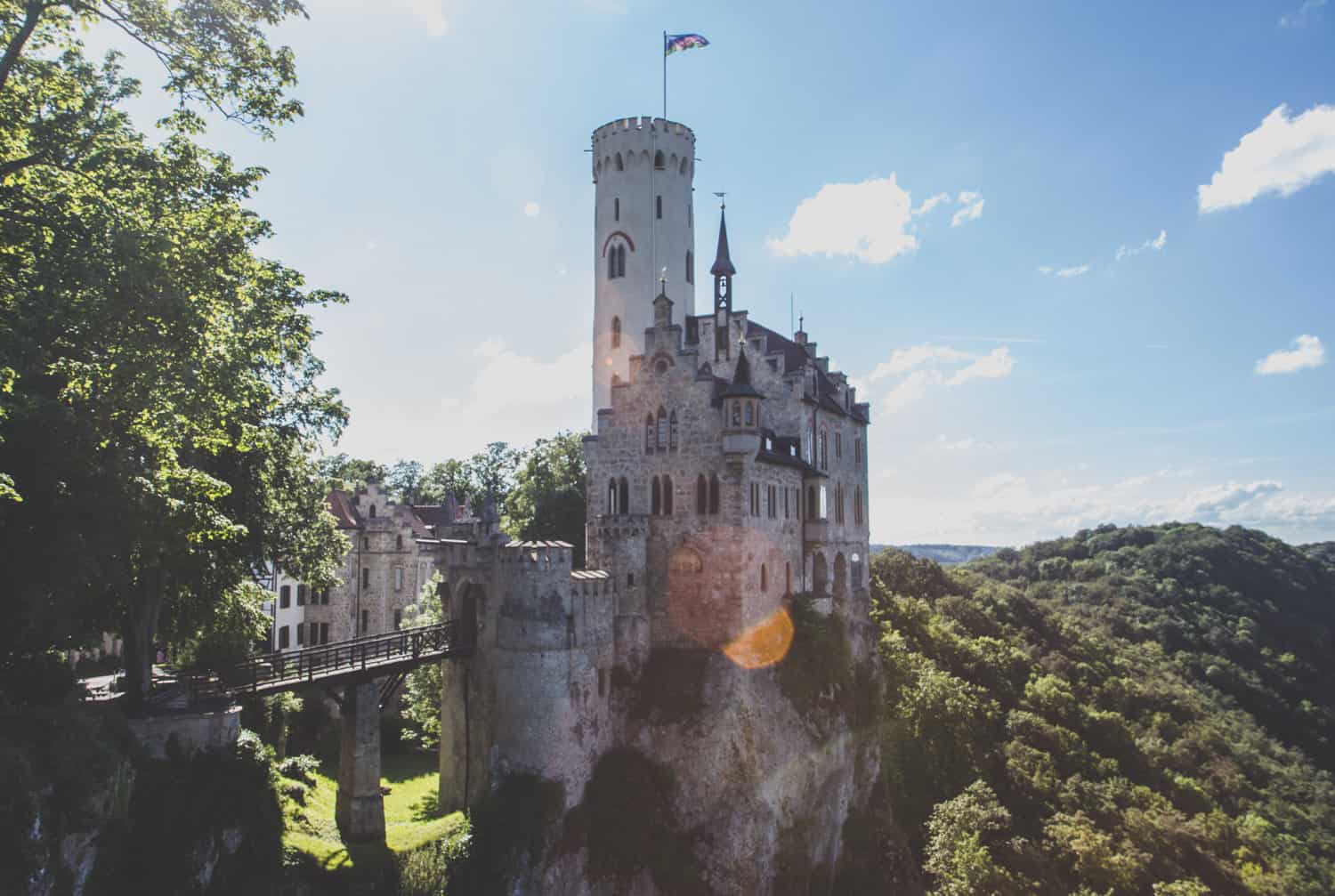 Schloss Lichtenstein, large old castle with a tower with a flag on it in Baden-Württemberg, Germany