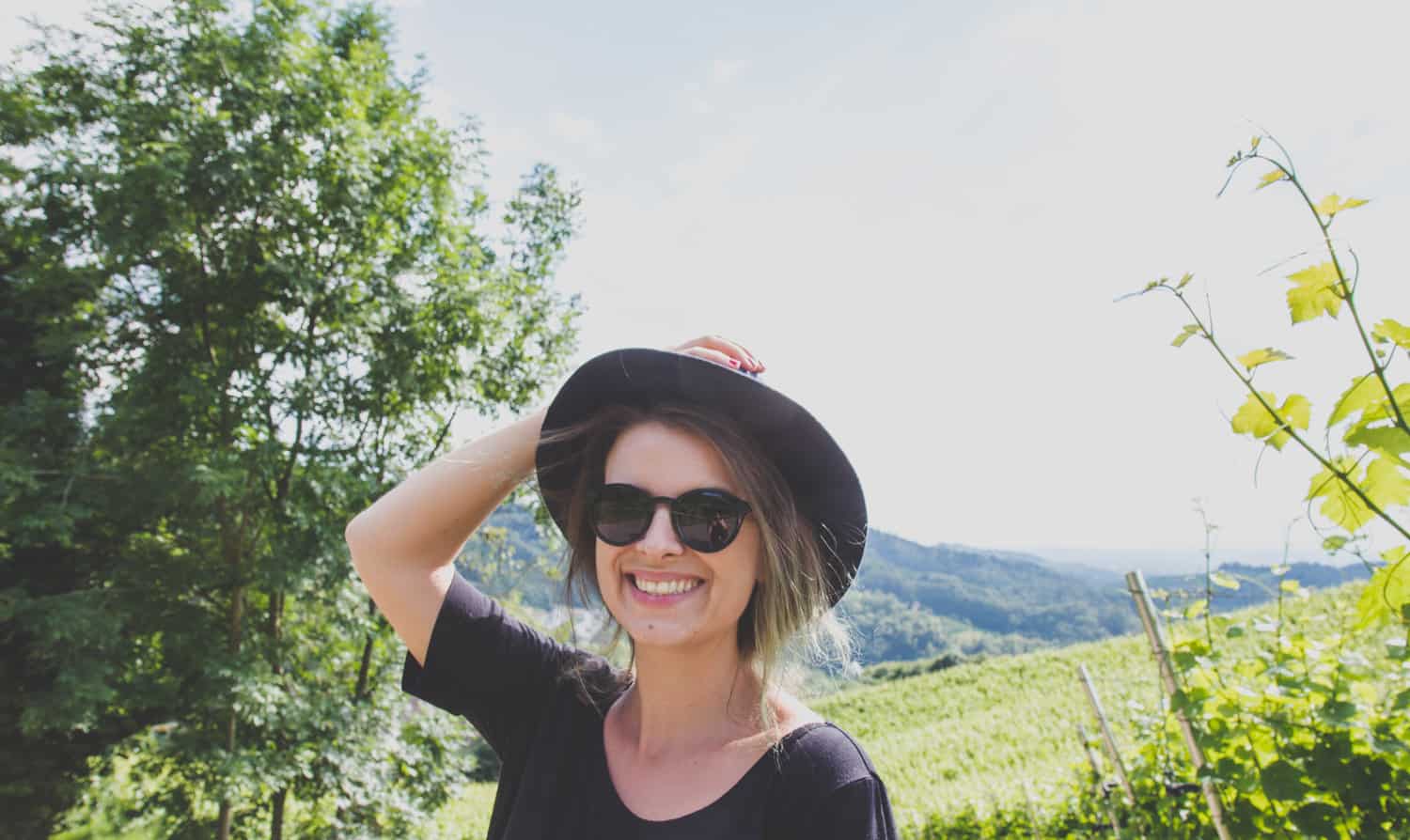 Women smiles in a black hat in Sasbachwalden