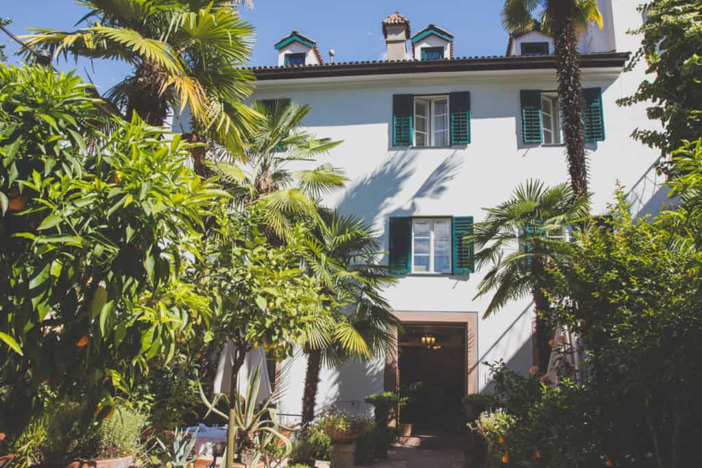 White building entrance with palm trees 