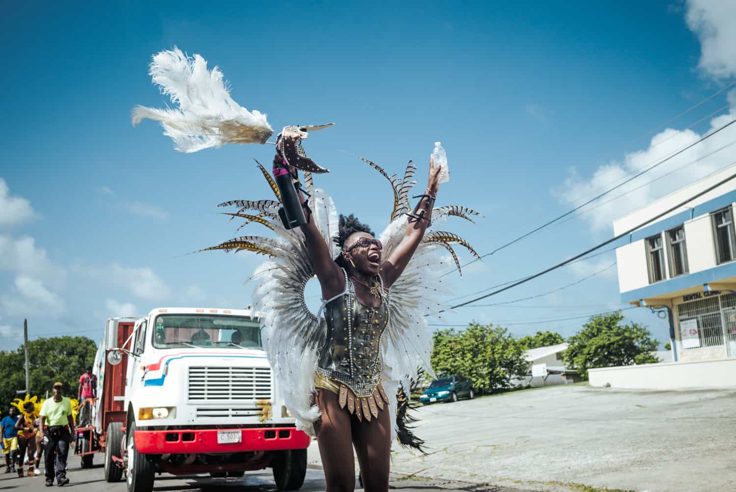 smiling women in a bird costume with her hands up in the air in celebration