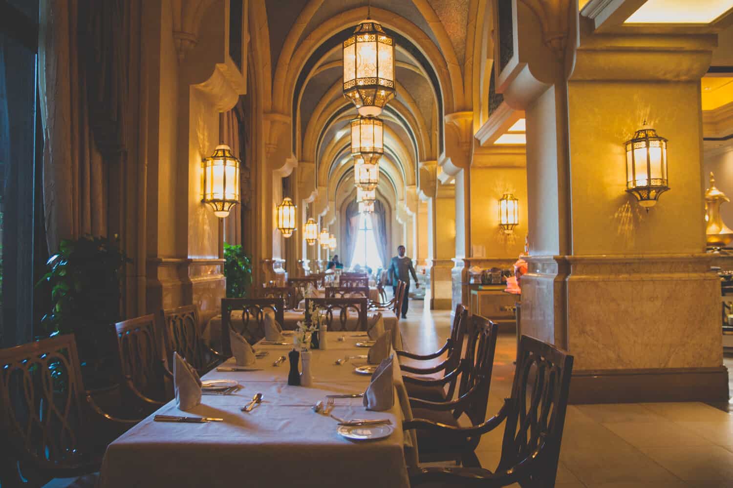grand dining room with table under large archway at the emirates palace abu dhabi