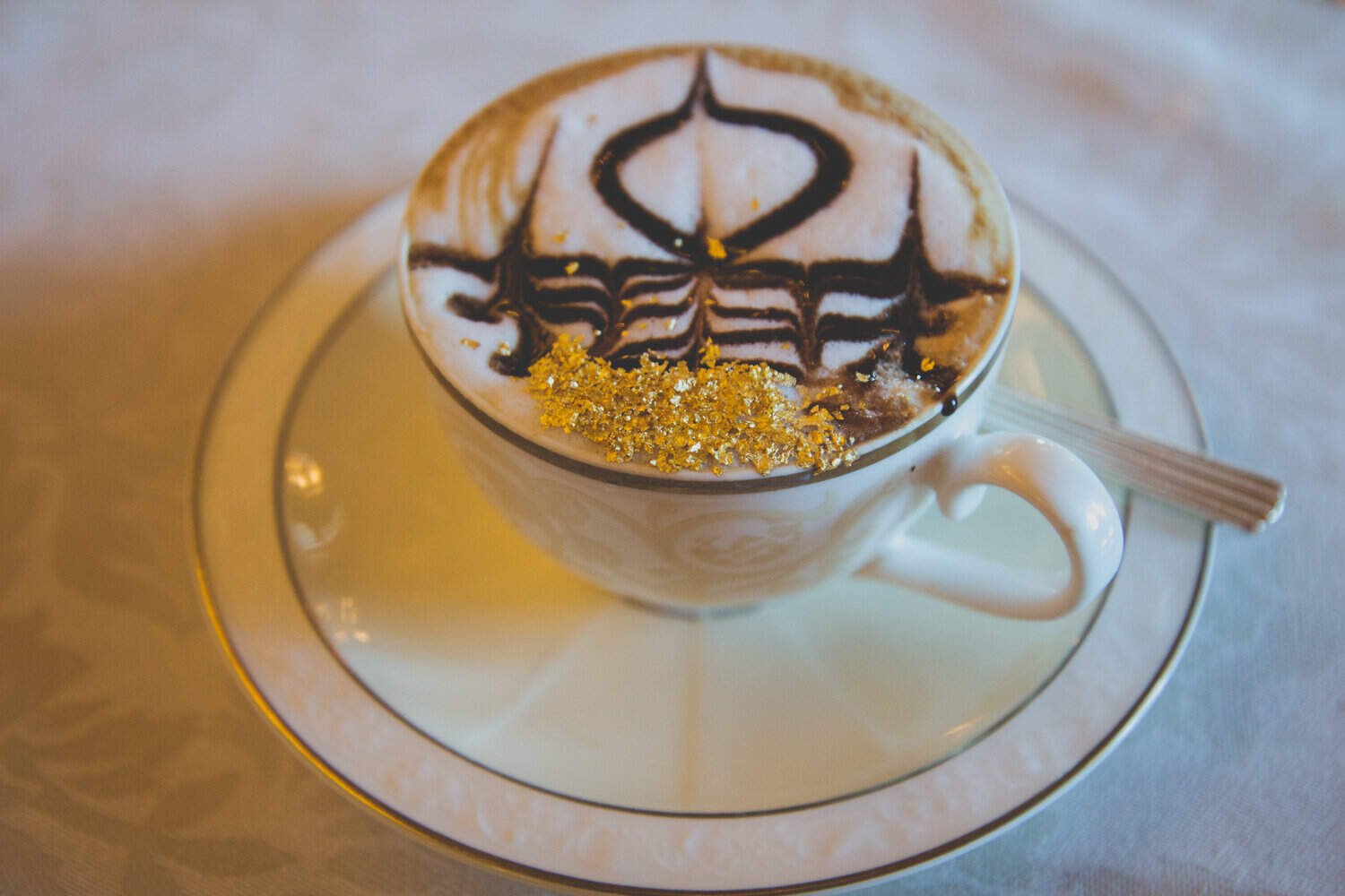 golden cappuccino with chocolate design and gold flakes at the emirates palace