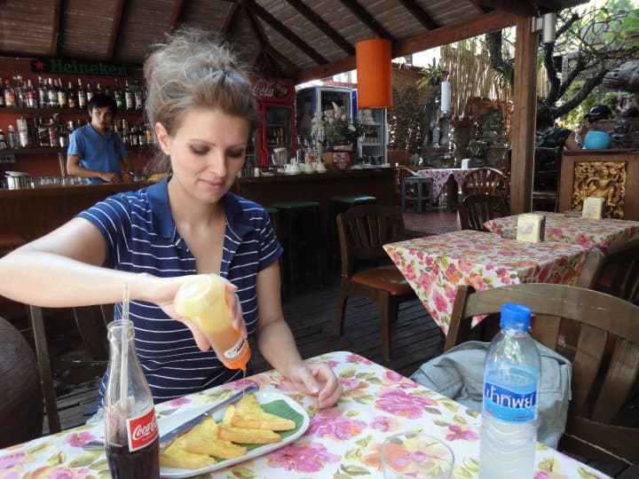 Woman eating at a table in a cafe