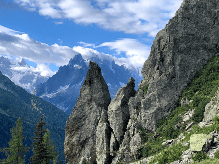 Snow covered Alps Mountain Range with large jagged stone in the front