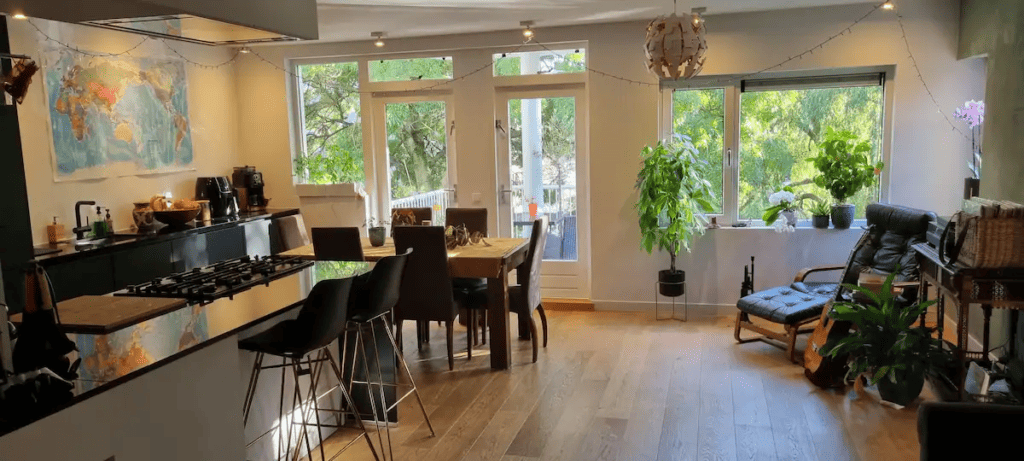 Living Room with kitchen and dining table in an apartment for rent via Airbnb Amsterdam Regels