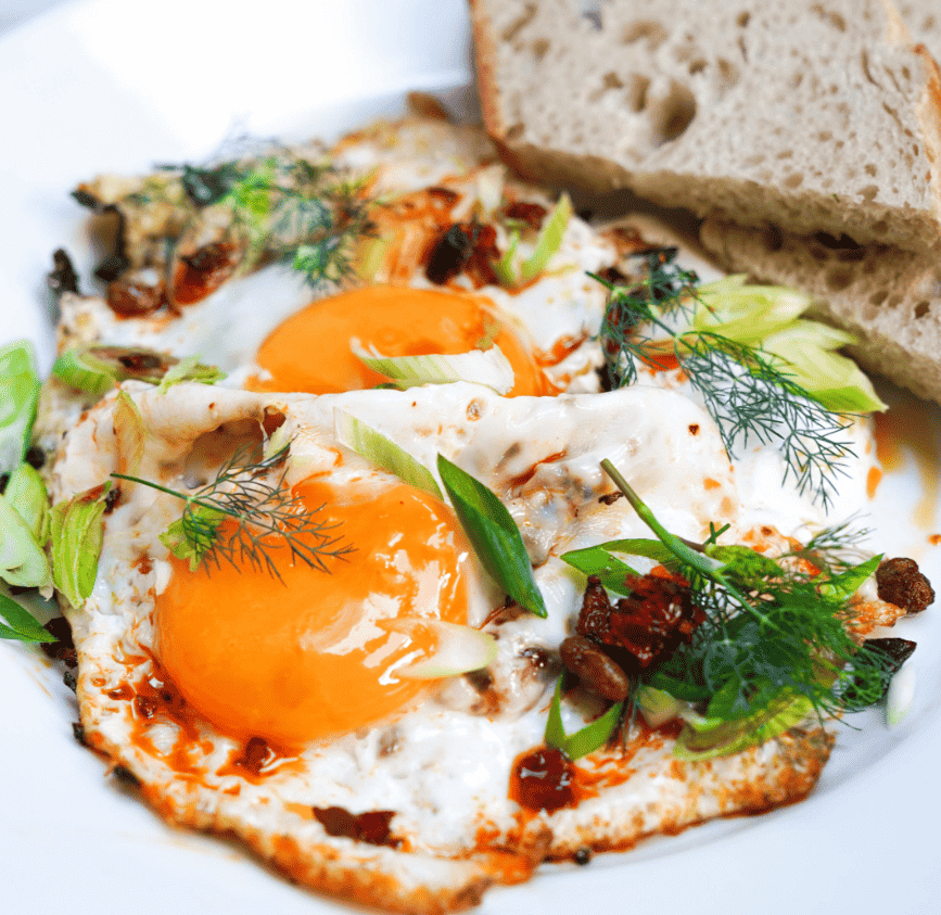 Two eggs with herbs and vegetables and toast at Ted's All Day Brunch