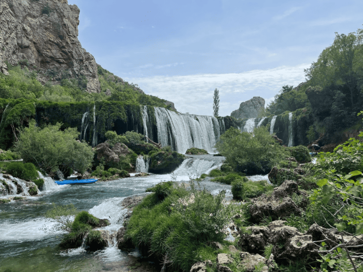 Large Waterfall into a river basin with a kayaking on zrmanja river