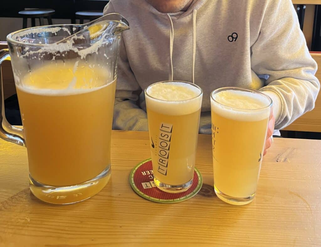 A pitcher and two glasses of beer at Troost Brewery Amsterdam  