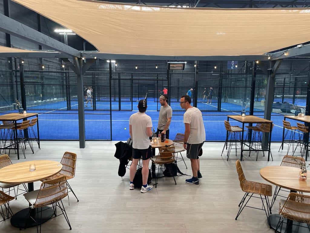 Three friends waiting to play padel netherlands 