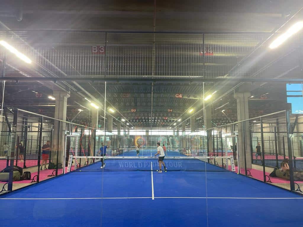 Two people playing padel netherlands in a blue court