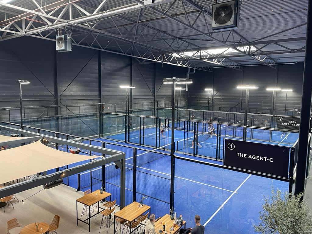 Three padel netherlands courts in front of a bar 