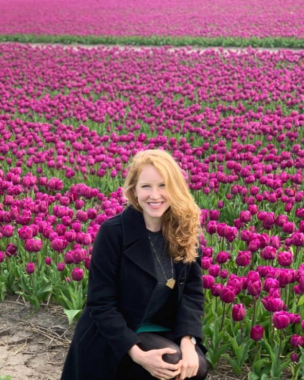 Smiling women in front a field of pink tulips