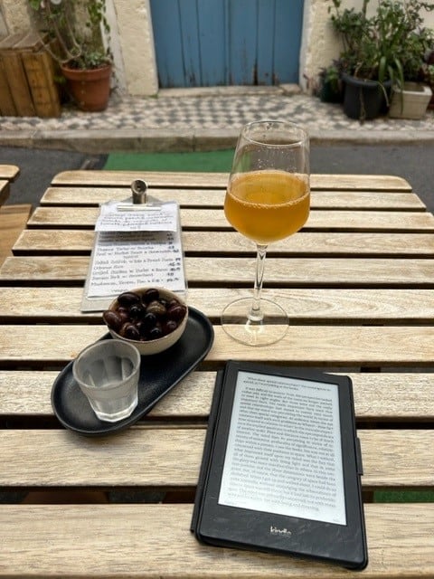Enjoy a glass of wine and olives and reading