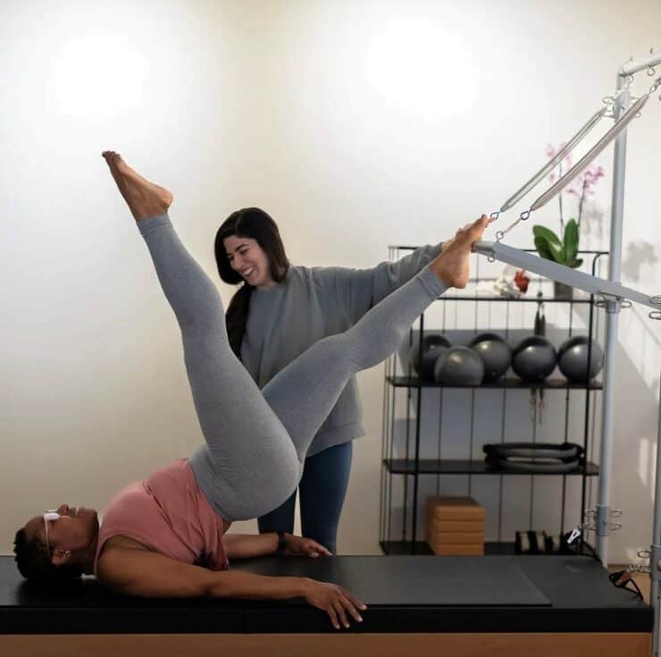 two women wear grey clothes at the gym