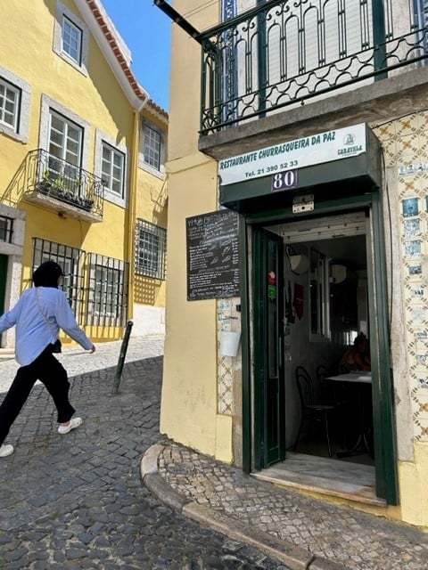 Person walking by the entrance of a restaurant