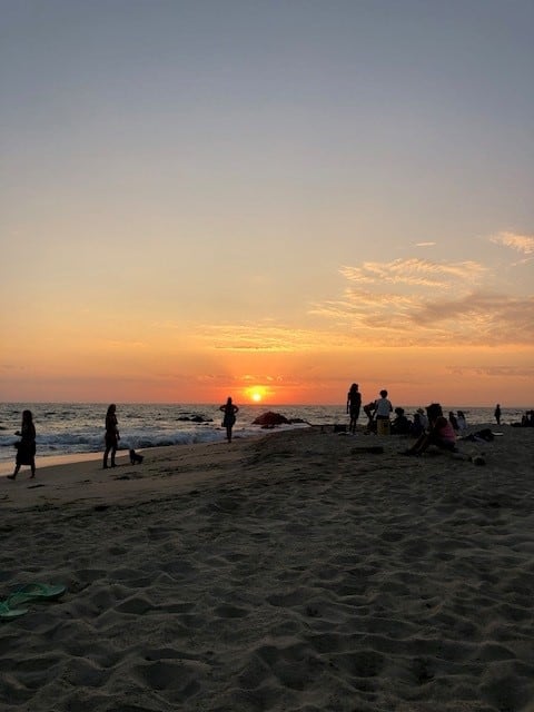 People at the beach watching the sunset