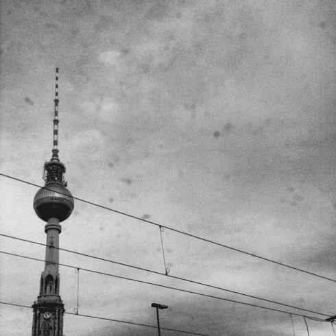 black and white photo of the Berlin TV Tower against a grey sky.