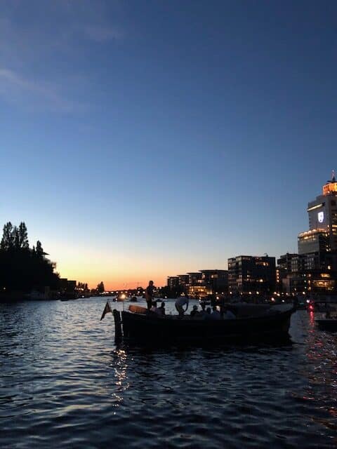 view of a boat on a canal at sunset