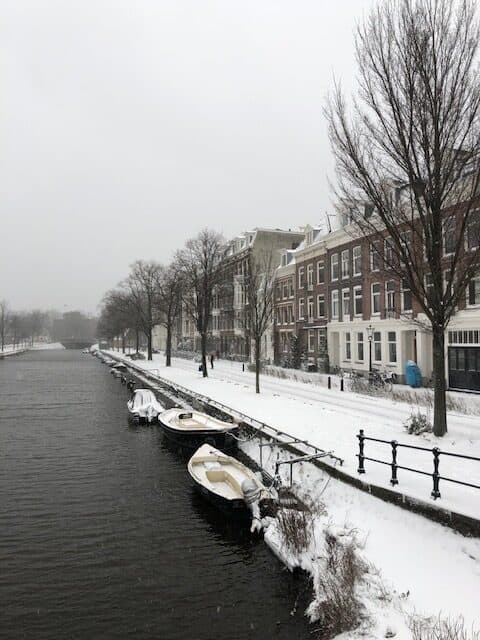 street view of houses and boats on a canal