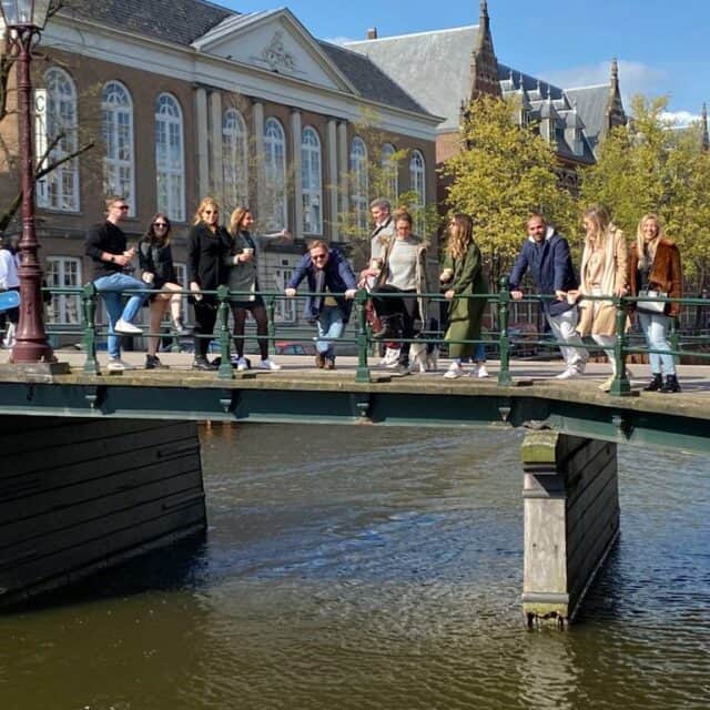 people standing on a bridge over a canal