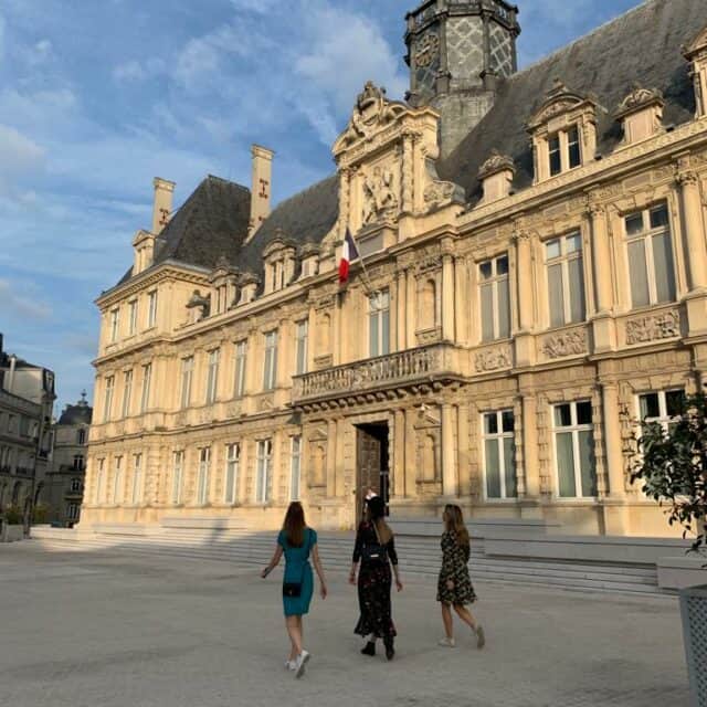 people walking on the street in front of a building