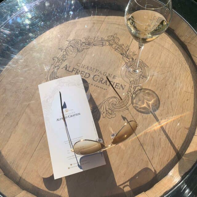 sunglasses and a wine glass in a table