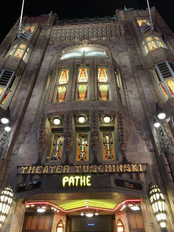 Mid Century Modern Building in the center of Amsterdam called Theater Tuschinski with a large yellow Pathe sign below a great spot for date ideas Amsterdam
